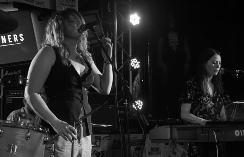Vocalist and keys player, black and white frame